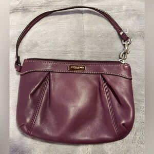 Plum colored Coach wristlet